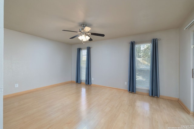 empty room featuring light hardwood / wood-style flooring and ceiling fan