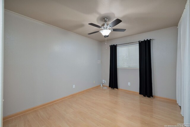 spare room with light hardwood / wood-style floors, ceiling fan, and crown molding