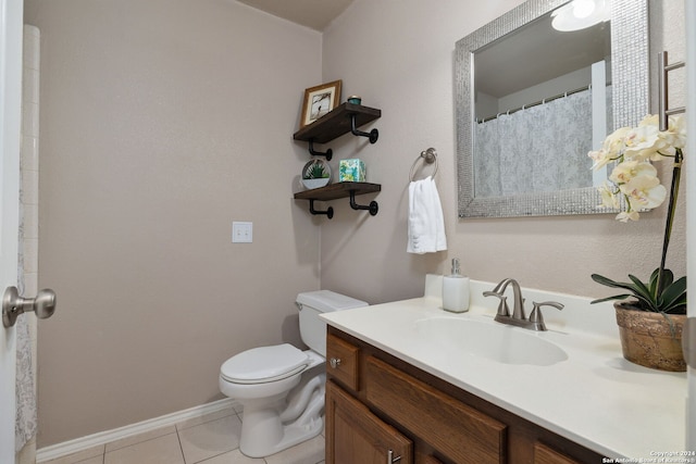 bathroom featuring tile patterned flooring, vanity, and toilet