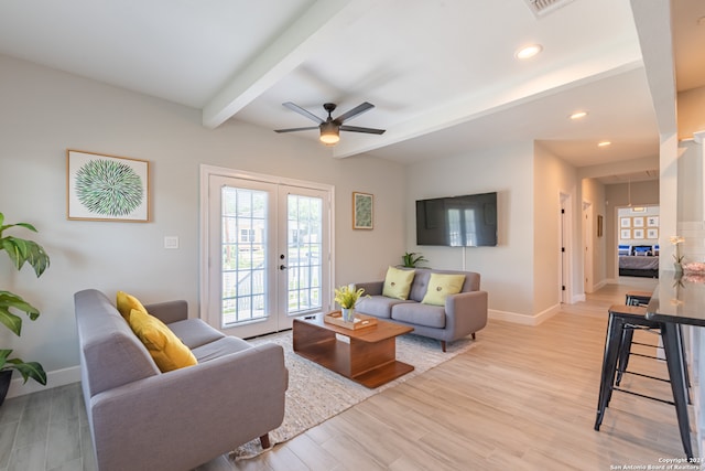 living room with beamed ceiling, ceiling fan, light wood-type flooring, and french doors