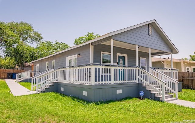 view of front of property with covered porch and a front yard