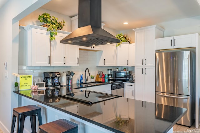 802 Piedmont Ave, San Antonio, TX 78210 - kitchen with appliances with stainless steel finishes, island range hood, decorative backsplash, white cabinets, and recessed lighting