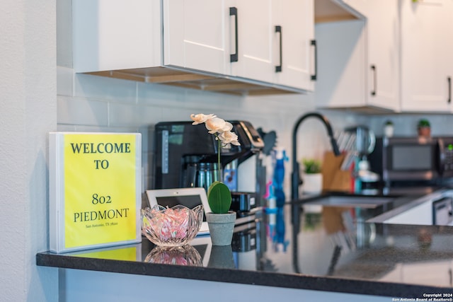 interior details featuring white cabinets and backsplash