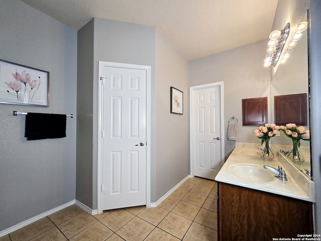 bathroom featuring tile patterned flooring and vanity