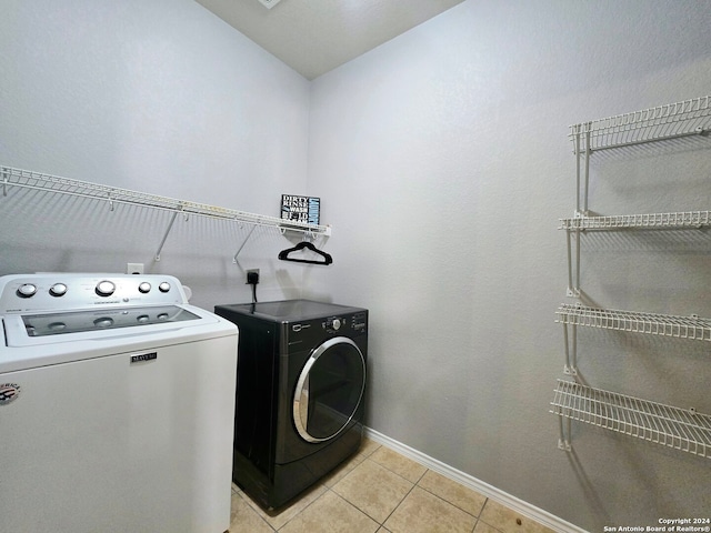 laundry room with light tile patterned flooring and independent washer and dryer