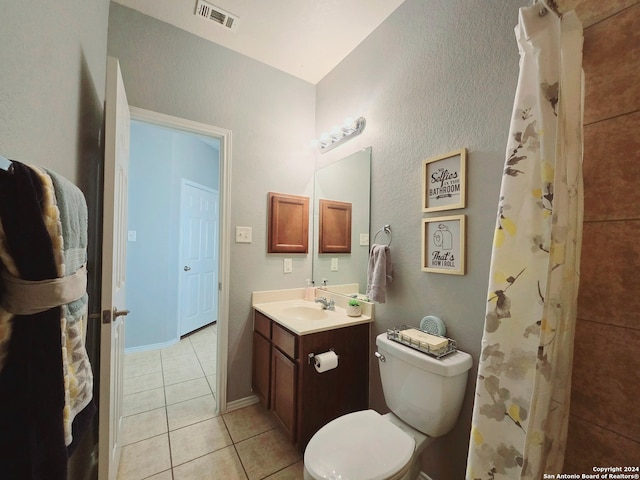 bathroom featuring tile patterned flooring, vanity, and toilet