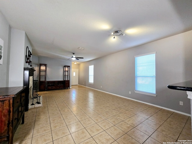 tiled living room with ceiling fan