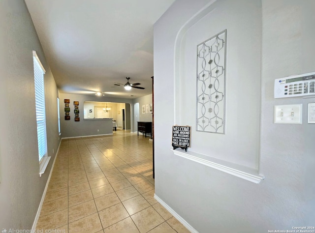 hall with light tile patterned floors