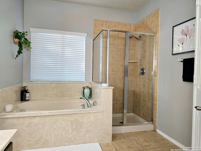 bathroom with shower with separate bathtub, vanity, and tile patterned floors