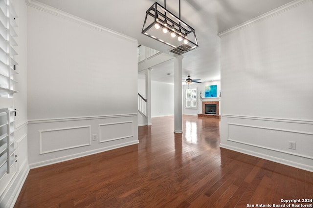 interior space with dark hardwood / wood-style floors, ceiling fan, and crown molding