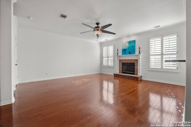 unfurnished living room featuring hardwood / wood-style flooring and ornamental molding