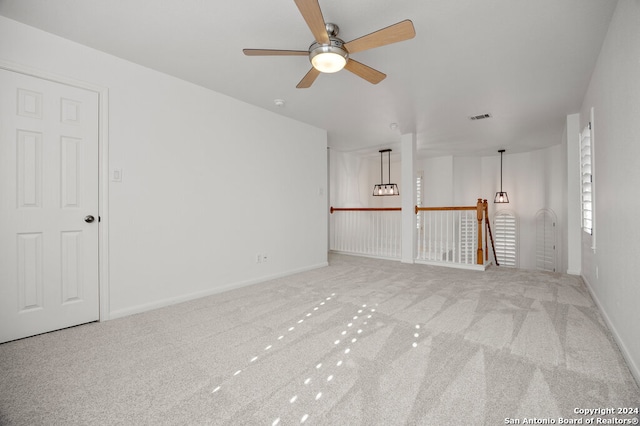 spare room with ceiling fan and carpet