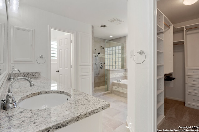 bathroom with separate shower and tub and vanity