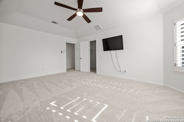 unfurnished bedroom with light carpet, multiple windows, and ceiling fan