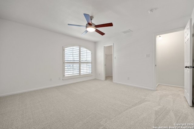 unfurnished room featuring light colored carpet and ceiling fan