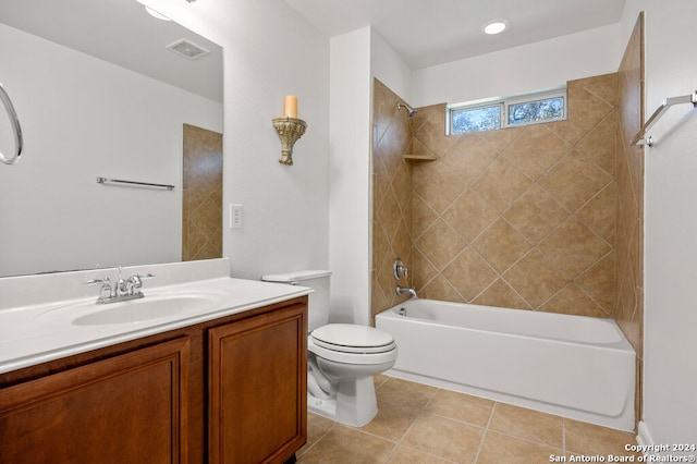 full bathroom with tile patterned flooring, vanity, tiled shower / bath combo, and toilet