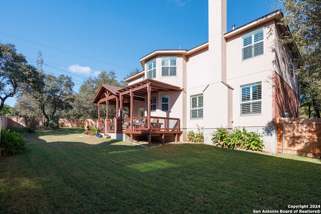 back of property featuring a pergola, a yard, and a wooden deck