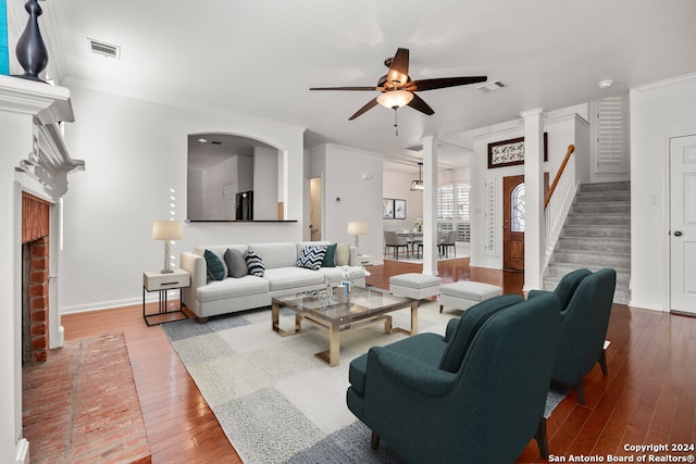 living room featuring hardwood / wood-style flooring, ceiling fan, and crown molding