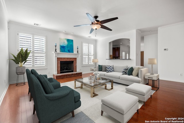 living room featuring plenty of natural light, wood-type flooring, and crown molding