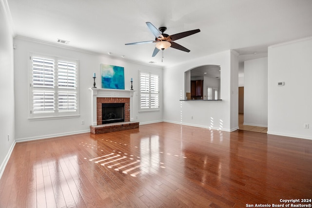 unfurnished living room featuring crown molding, ceiling fan, plenty of natural light, and wood-type flooring