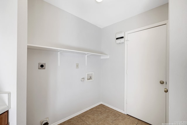 laundry area with hookup for an electric dryer, hookup for a washing machine, and light tile patterned flooring