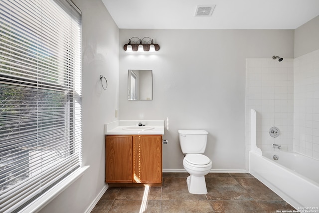 full bathroom with tiled shower / bath combo, toilet, and vanity