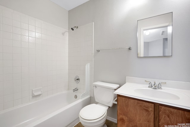 full bathroom featuring tiled shower / bath, vanity, and toilet