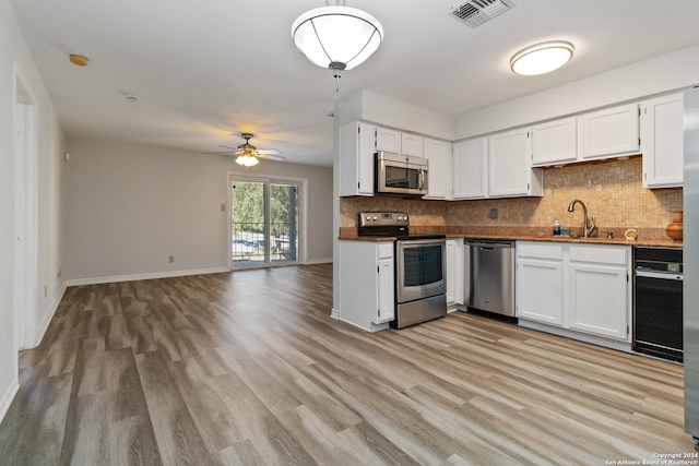 kitchen featuring appliances with stainless steel finishes, ceiling fan, sink, light hardwood / wood-style flooring, and white cabinetry