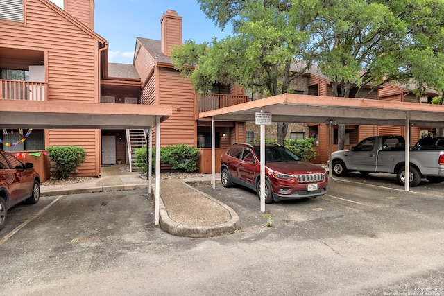 view of vehicle parking featuring a carport