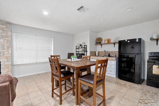 tiled dining room with sink