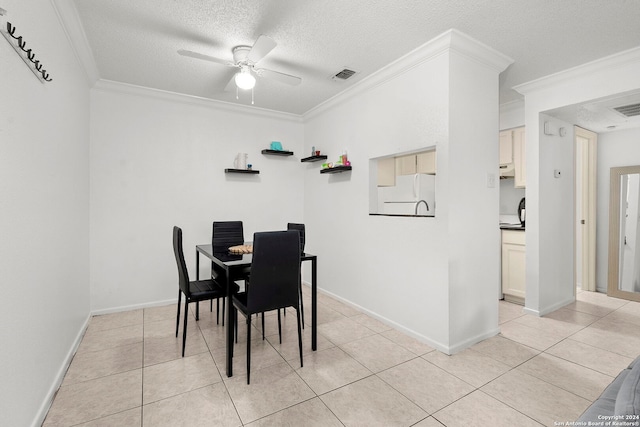 tiled dining space featuring a textured ceiling, ceiling fan, and ornamental molding