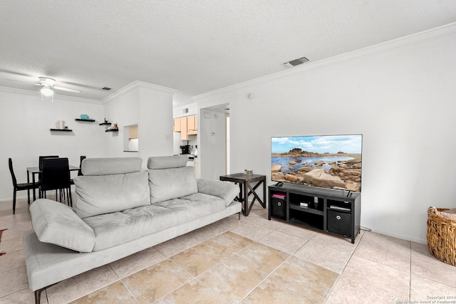 tiled living room featuring a textured ceiling, ceiling fan, and crown molding