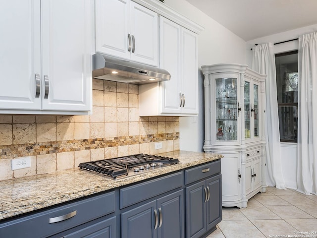 kitchen with white cabinets, light tile patterned floors, and stainless steel gas cooktop