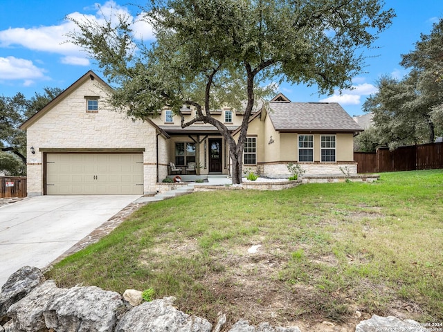 view of front of home featuring a front yard and a garage