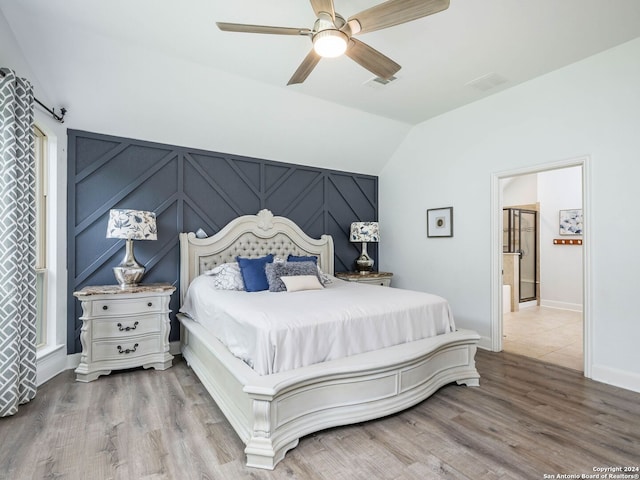 bedroom featuring hardwood / wood-style floors, ceiling fan, and vaulted ceiling