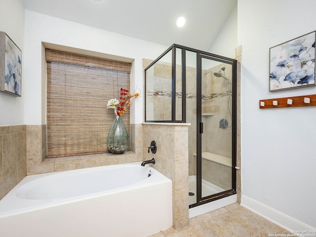 bathroom with tile patterned floors, lofted ceiling, and shower with separate bathtub