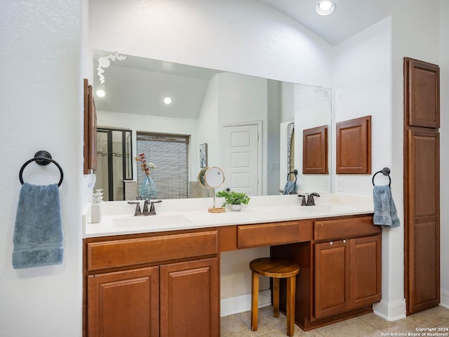 bathroom with tile patterned flooring, lofted ceiling, vanity, and a shower with shower door