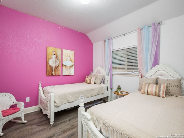 bedroom with lofted ceiling and dark wood-type flooring