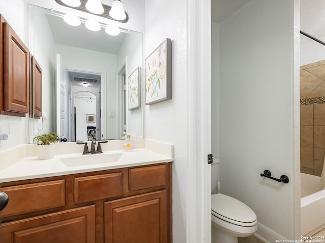 full bathroom with vanity, toilet, and tiled shower / bath