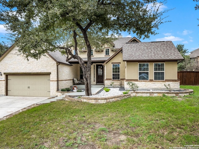 view of front of house with a front yard and a garage