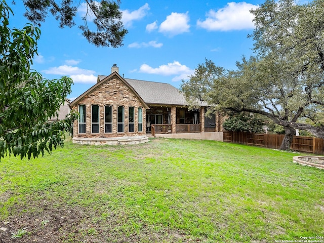 back of house with a yard