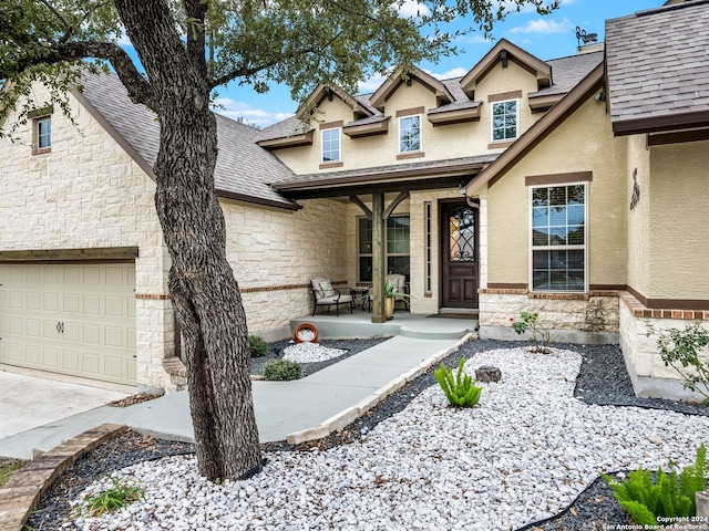 view of front of home featuring a porch and a garage