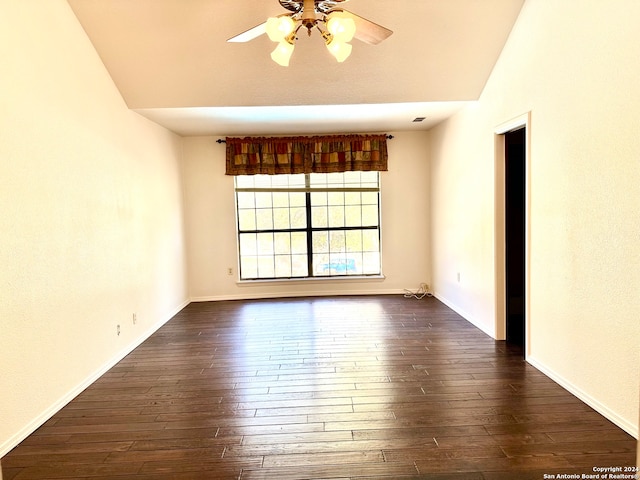 spare room featuring ceiling fan, lofted ceiling, and dark wood-type flooring