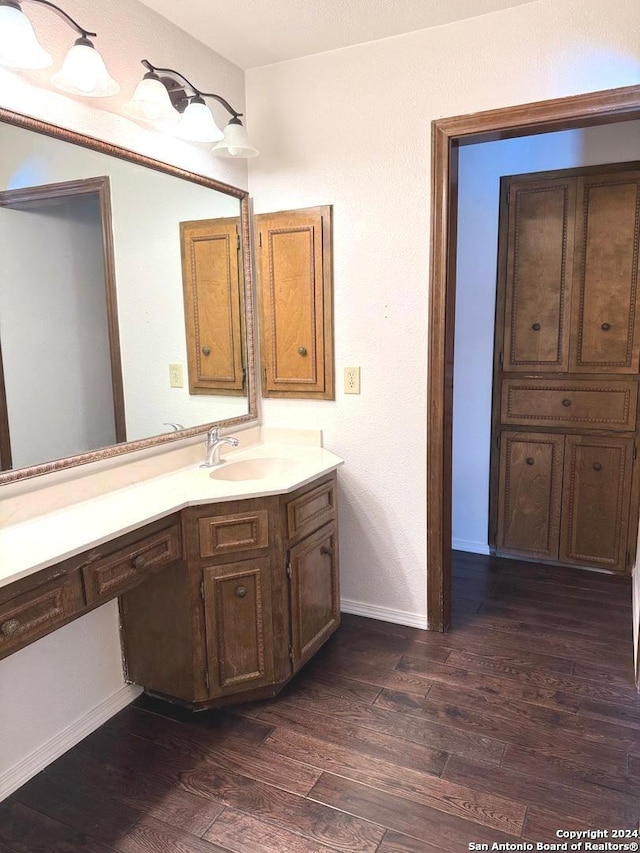 bathroom with hardwood / wood-style flooring and vanity