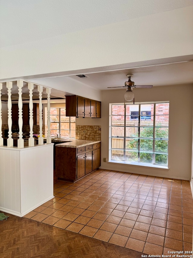 kitchen featuring ceiling fan, plenty of natural light, and light tile patterned flooring