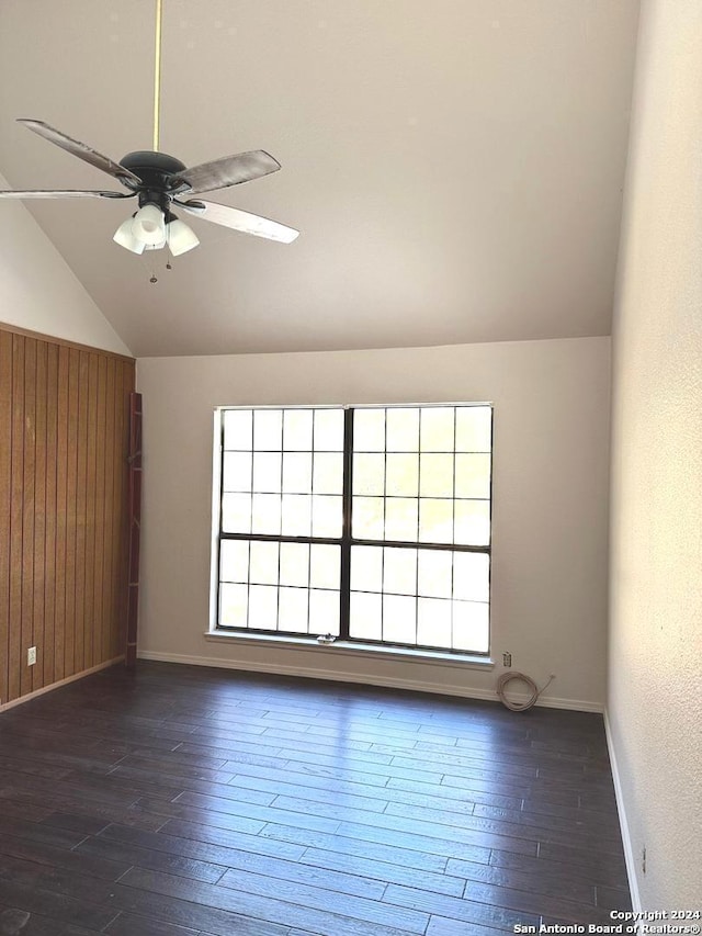 empty room featuring ceiling fan, plenty of natural light, and dark hardwood / wood-style floors