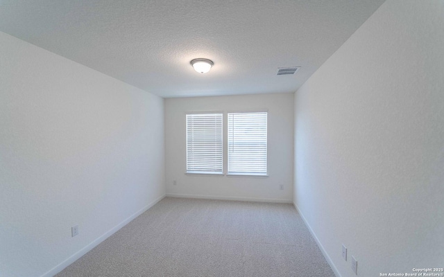 unfurnished room featuring a textured ceiling and carpet floors