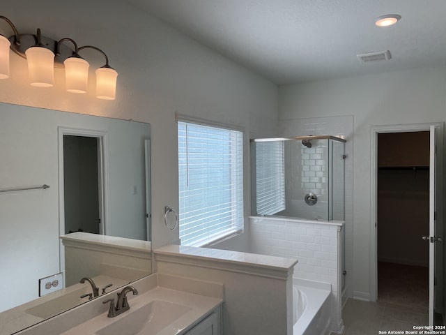 bathroom with tile patterned flooring, vanity, independent shower and bath, and a healthy amount of sunlight