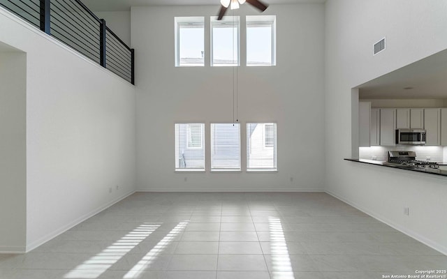 127 Gathering Dr, San Antonio, TX 78253 - unfurnished living room featuring a high ceiling, ceiling fan, and light tile patterned flooring