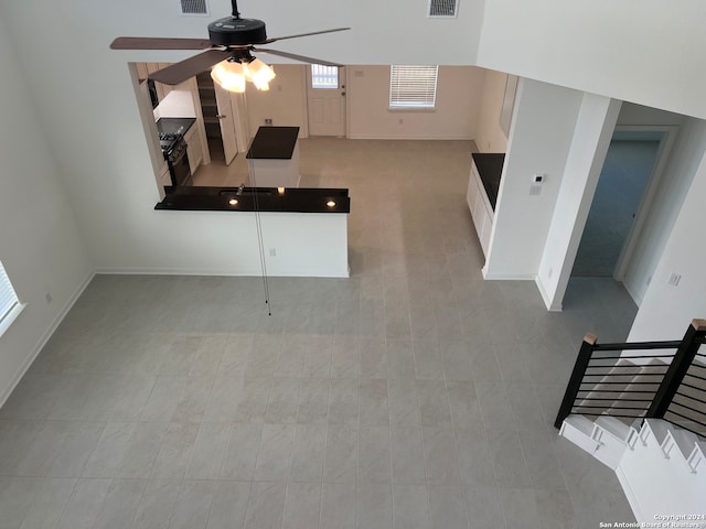 unfurnished living room with ceiling fan